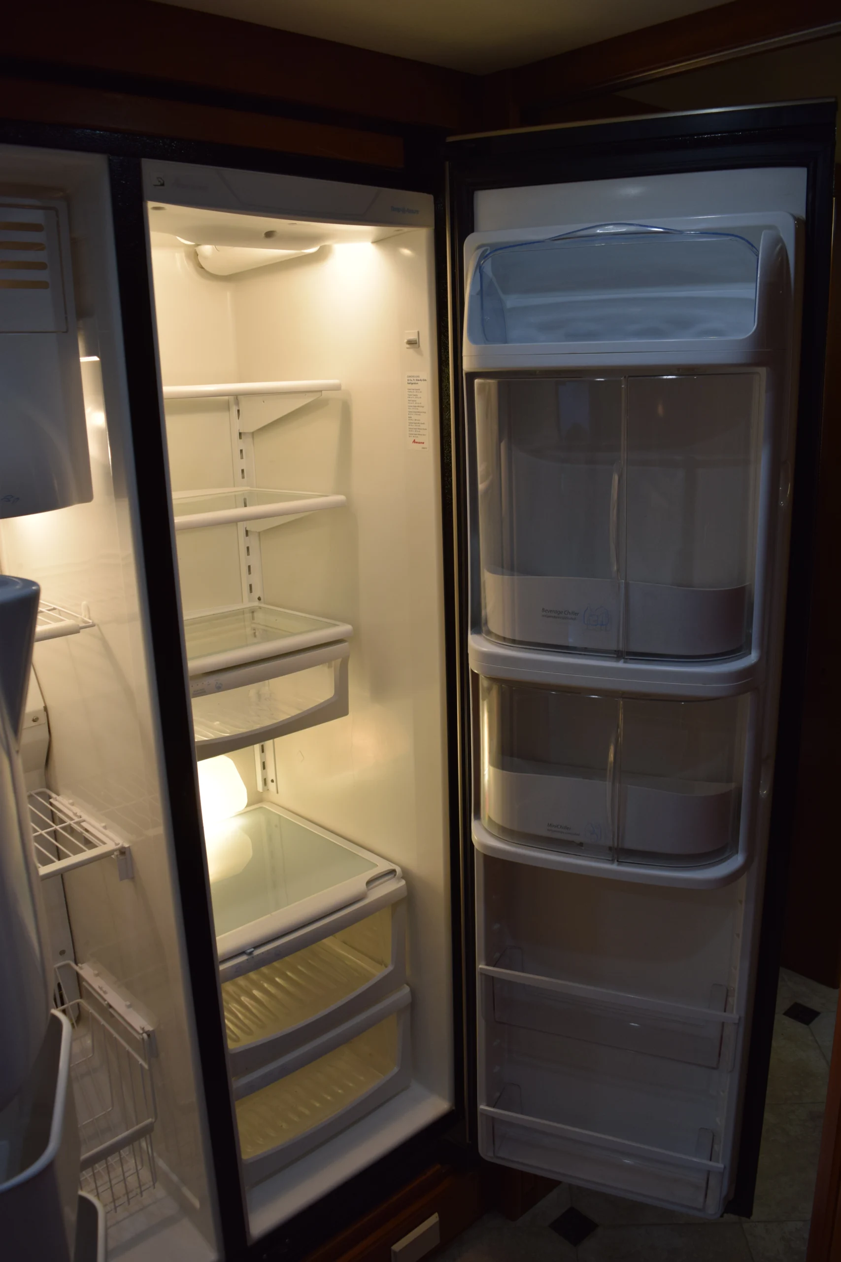 DSC_0177 Open fridge with empty shelves and door compartments, suitable for Motorcoach and RVs.