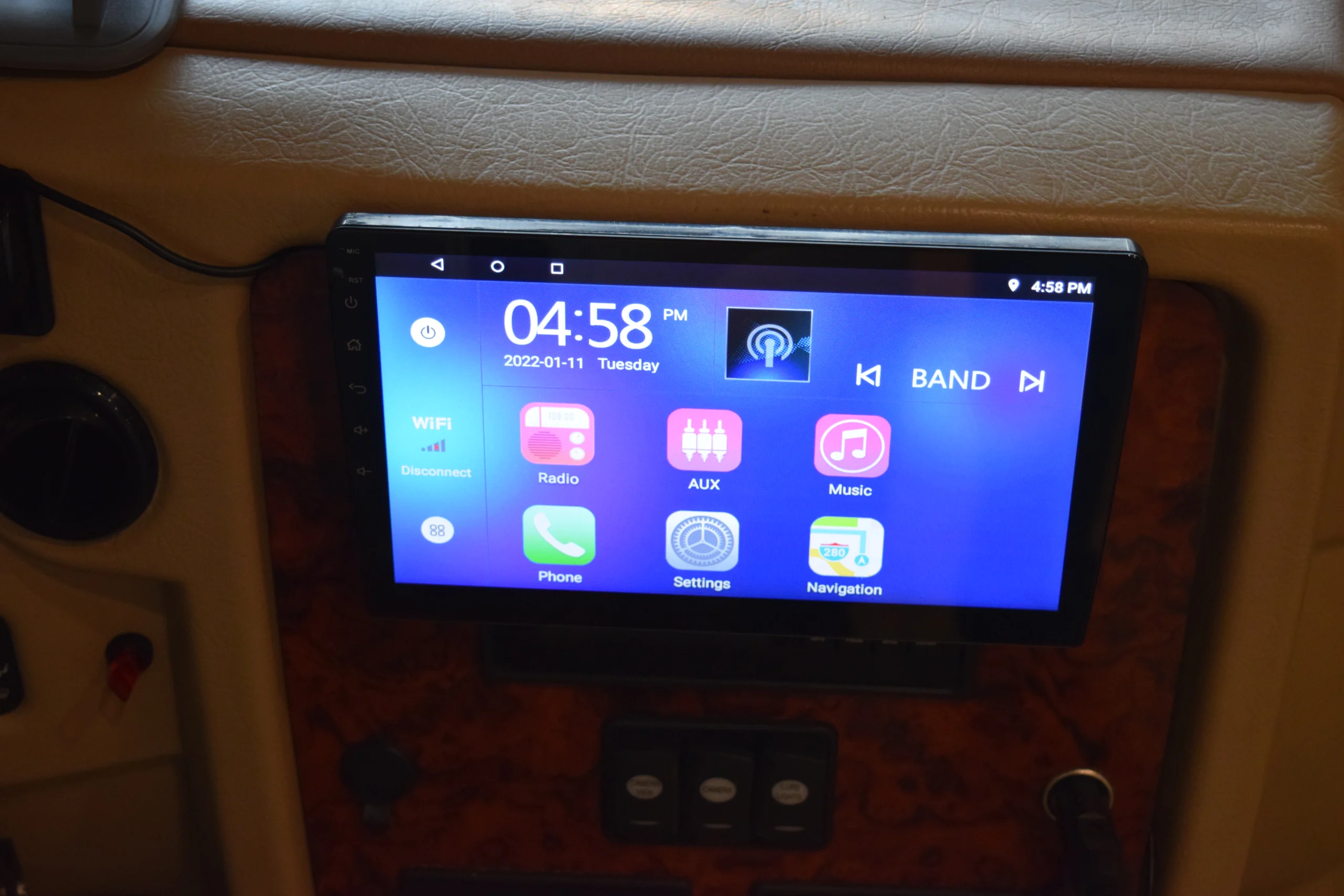 DSC_0186 Dashboard touchscreen in a Motorcoach and RVs, displaying time, date, and apps like Radio, AUX, Music, and Navigation.