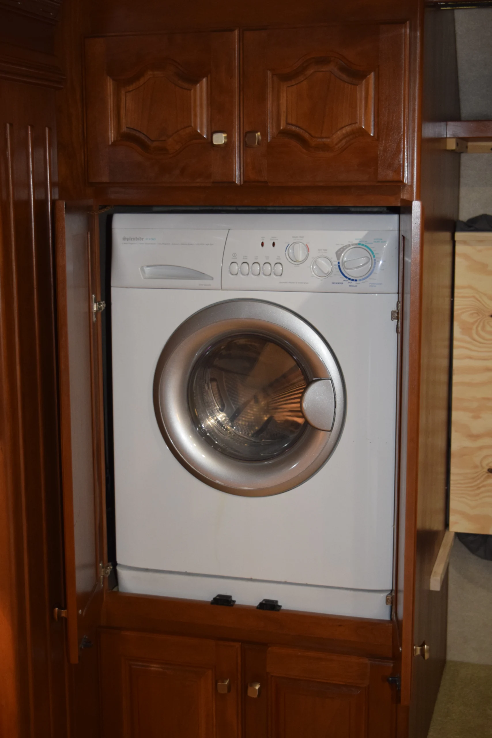 DSC_0191 Front-loading washer in a wooden cabinet, ideal for space-saving needs in motorcoaches and RVs.