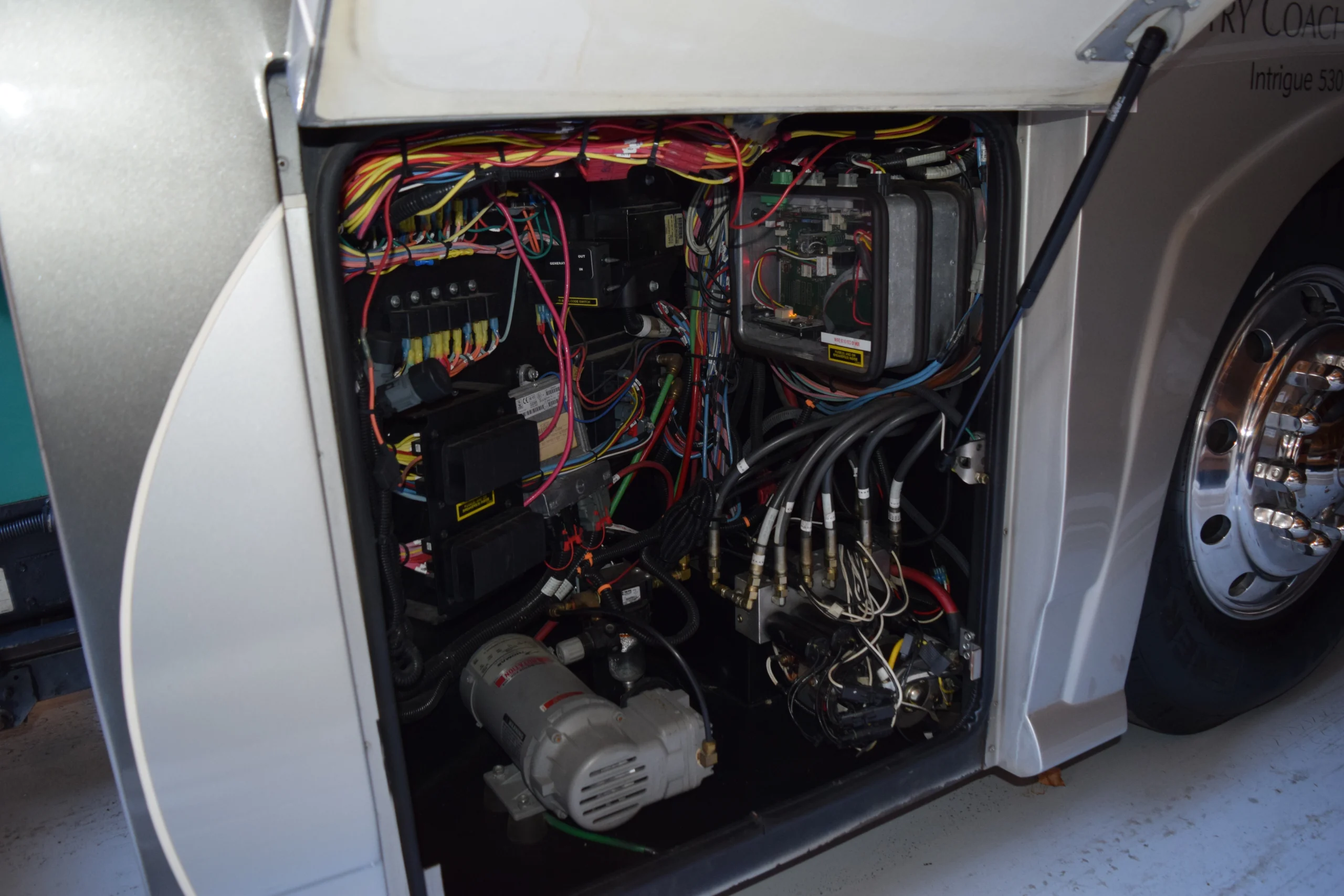 DSC_0214 Open panel of a Motorcoach and RVs showing complex wiring, circuits, and electronic components with colorful cables.
