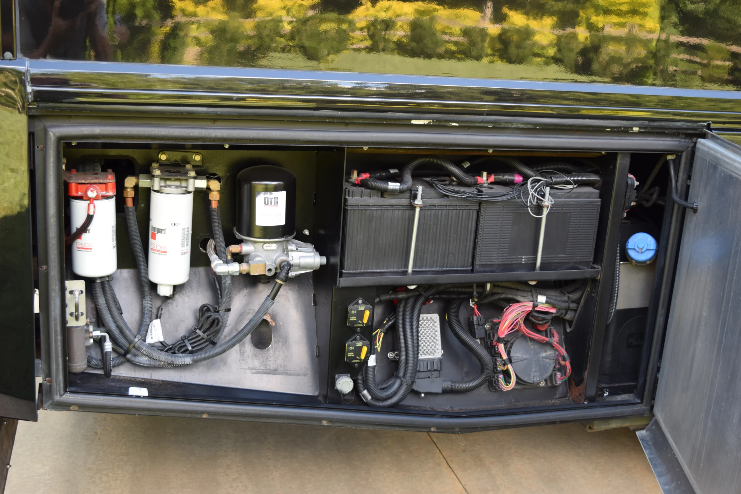 DSC_0353 Motorcoach and RVs electrical and fluid compartments with filters, wiring, and battery setup.