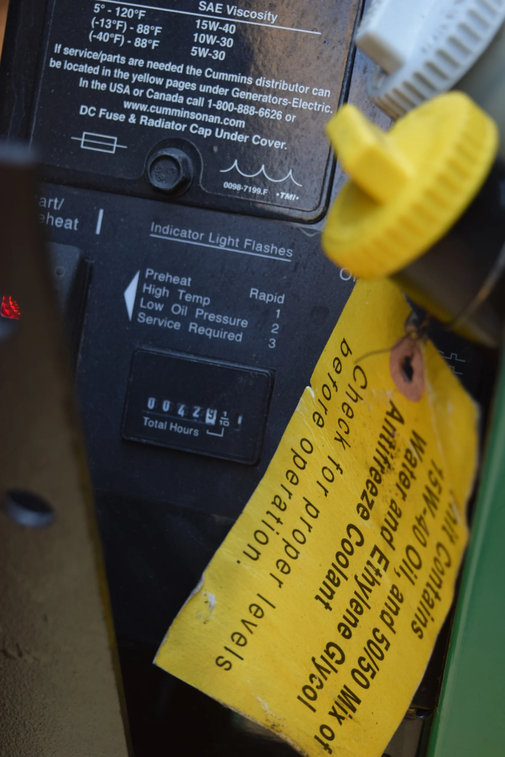 DSC_0706 Engine panel with oil viscosity chart, indicator light flashes guide, and yellow tag about coolant levels. Relevant for Motorcoach and RVs.