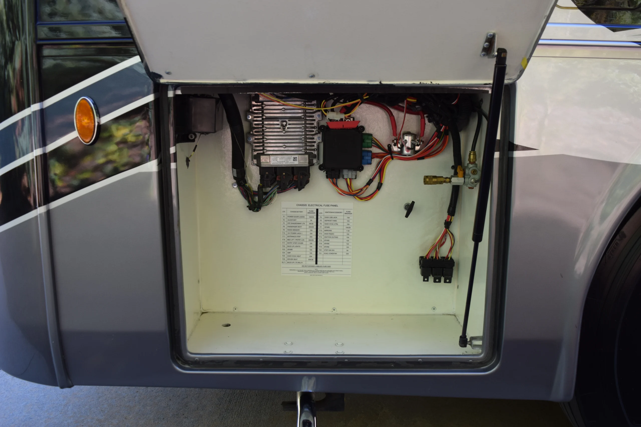 DSC_0709 Open electrical fuse panel compartment of a Motorcoach and RVs, showing wires, circuits, and a diagram.