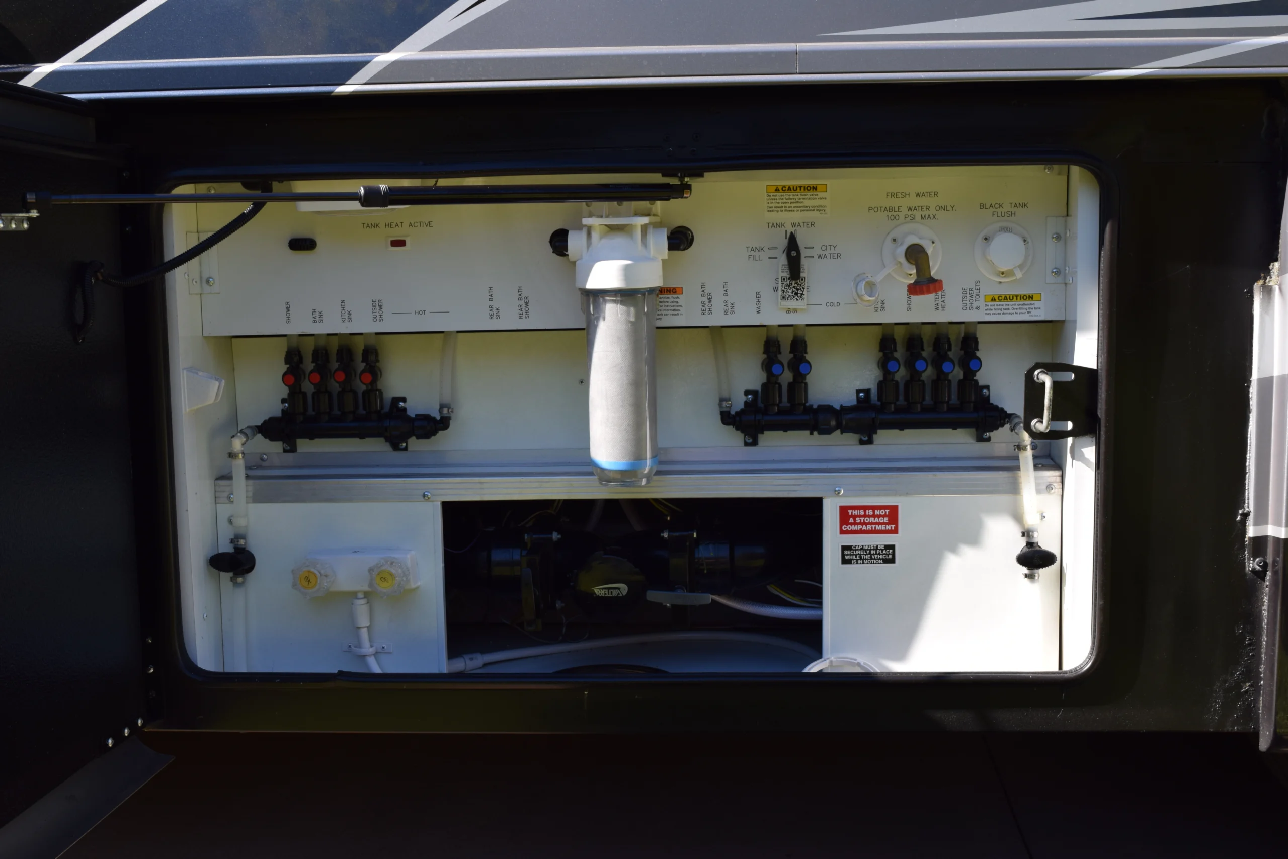 DSC_0770 RV utility control panel with labeled valves, filter, and water system controls, essential for Motorcoach and Rvs maintenance.