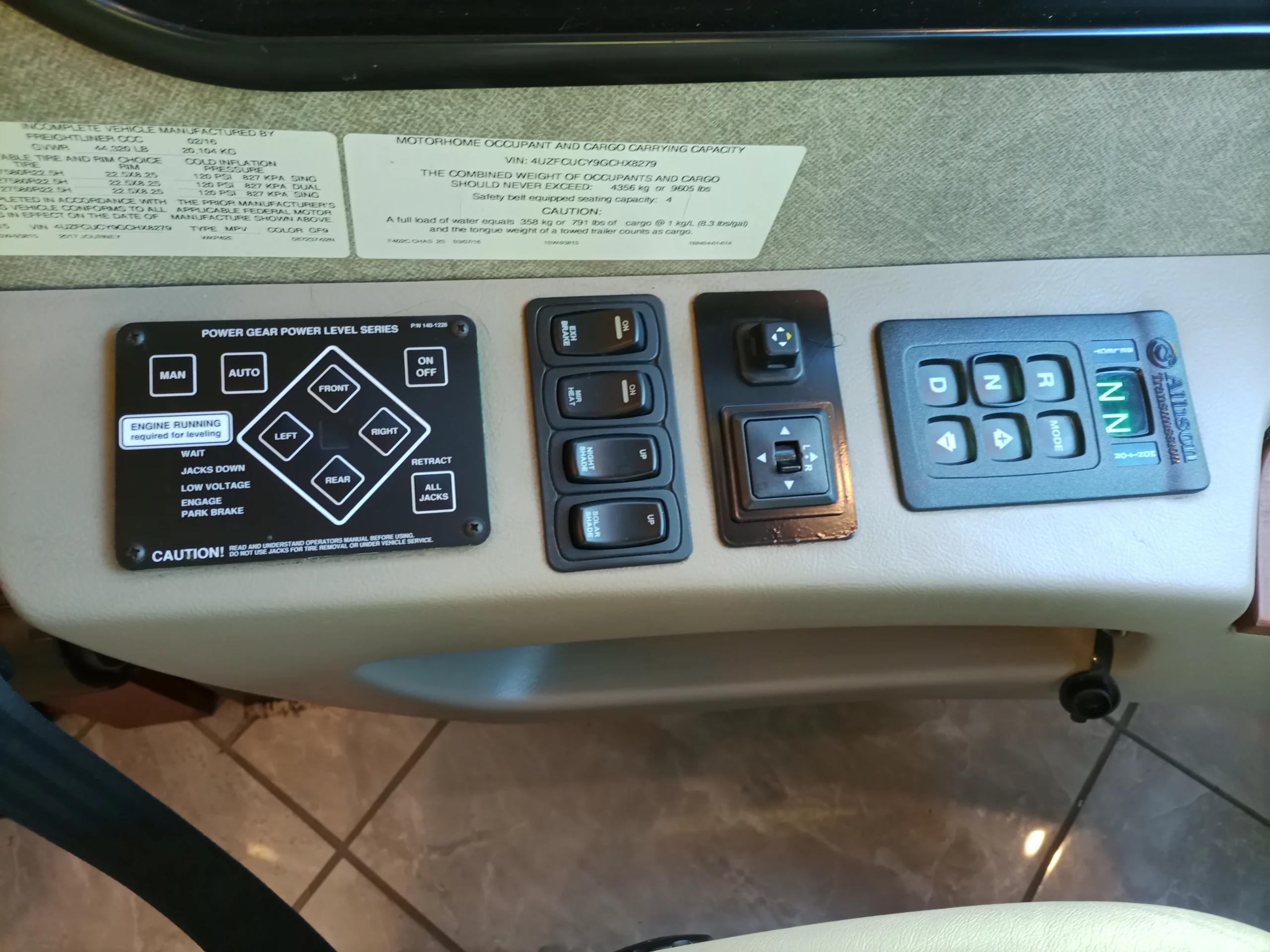 IMG_20260928_092421_064 Motorcoach and RVs control panel featuring gear level, directional buttons, and gearshift with illuminated neutral indicator.