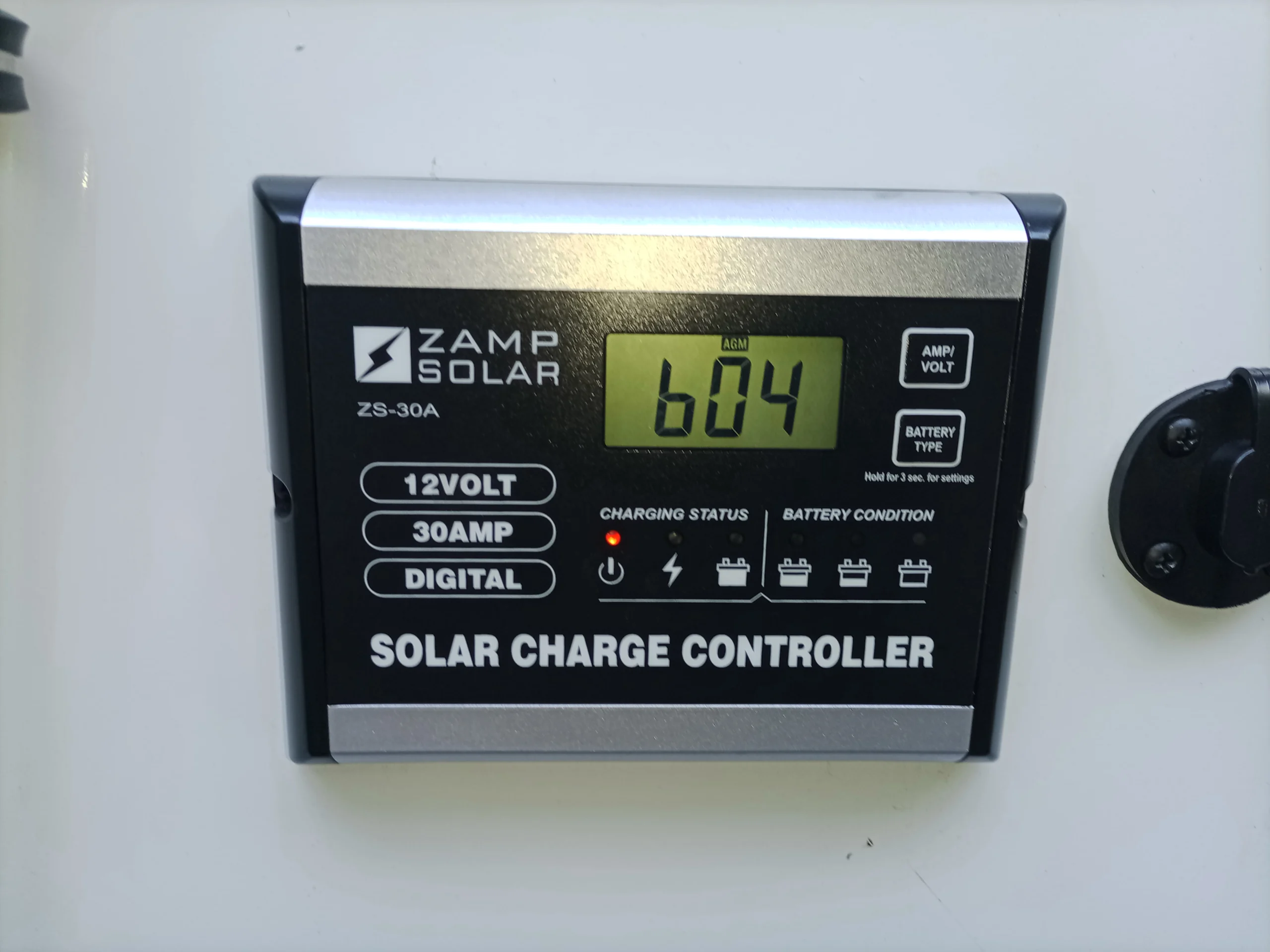 IMG_20260928_160223_305 Zamp Solar charge controller display showing 6.04 volts. Suitable for Motorcoach and RVs, with buttons for voltage and battery type.